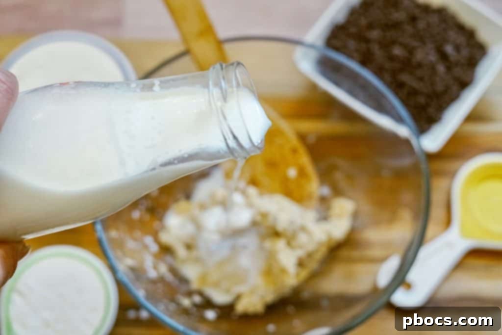 Adding milk to the butter and sugar mixture.