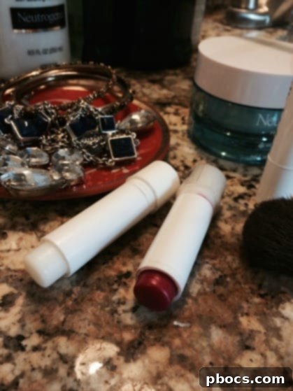 Applying red chapstick and clear lip balm for naturally pink and hydrated lips, completing the 5-minute makeup routine