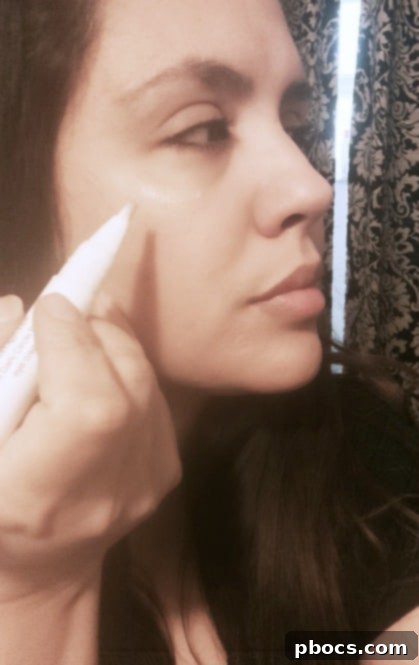 Close-up of a woman applying dark circle repair cream as part of her quick 5-minute morning makeup routine