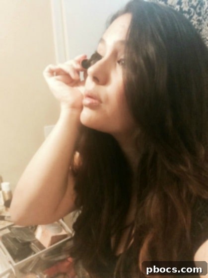 Applying mascara and subtle eyeliner for a quick 5-minute morning makeup routine to define eyes