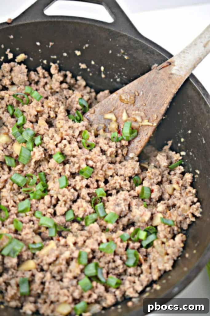 Garnish with Scallions Garnishing the finished meat mixture with scallions