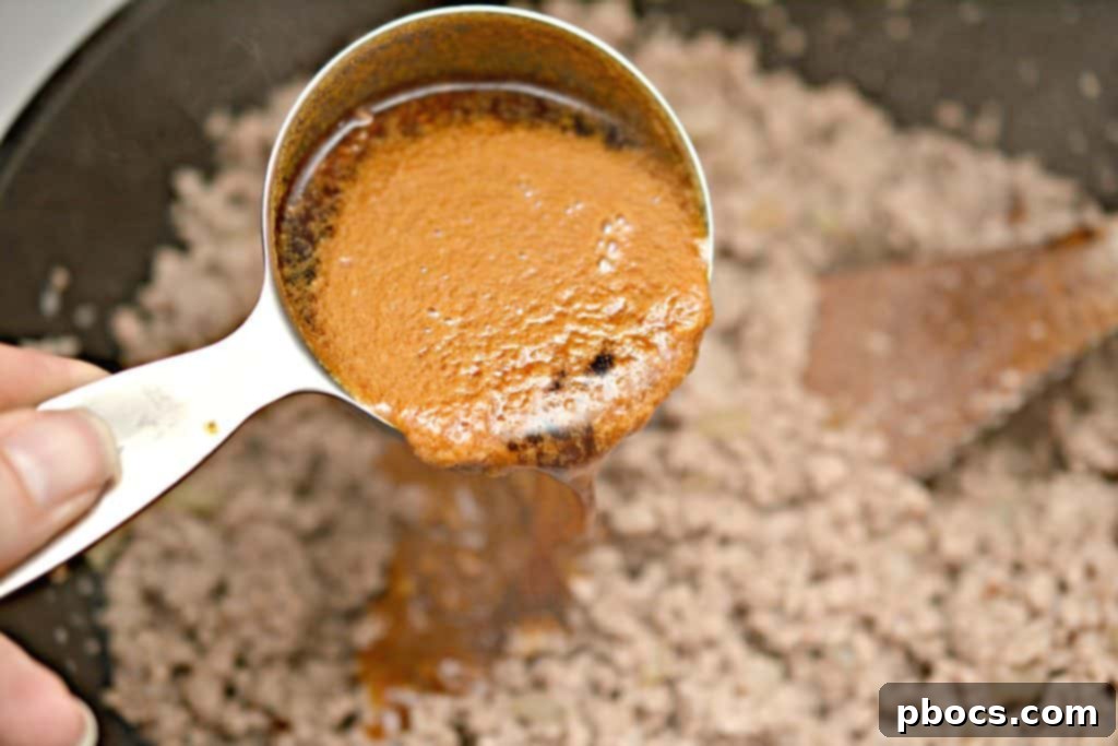 Browning Ground Meat Browning ground meat with onions in a skillet