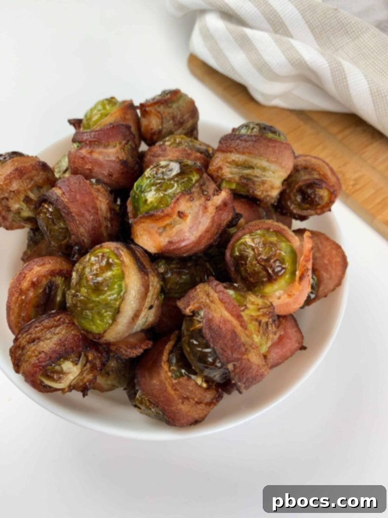Crispy Air Fryer Bacon Brussels Sprouts 3 Close-up of crispy Air Fryer Bacon Wrapped Brussel Sprouts on a plate