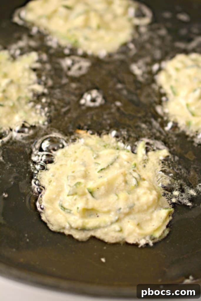 Savory Keto Zucchini Bites 12 Keto Zucchini Fritters preparation step: mixing ingredients in a bowl.