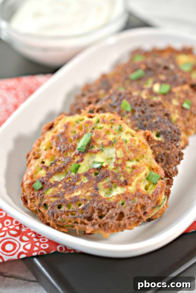 Savory Keto Zucchini Bites 3 Perfectly golden and crispy Keto Zucchini Fritters with a hint of green herbs.