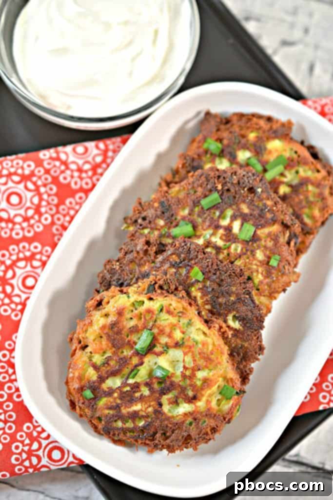 Savory Keto Zucchini Bites 4 Close-up of crispy Keto Zucchini Fritters stacked on a plate, ready to be served.