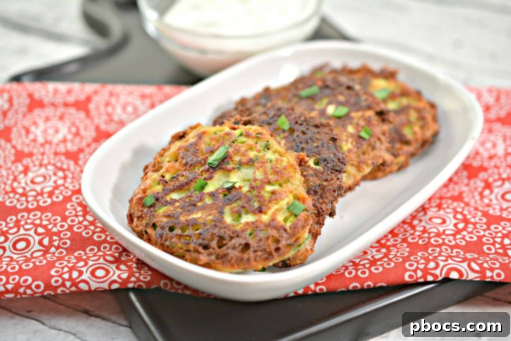Savory Keto Zucchini Bites 5 Overhead view of a prepared batch of Keto Zucchini Fritters on a cooling rack.