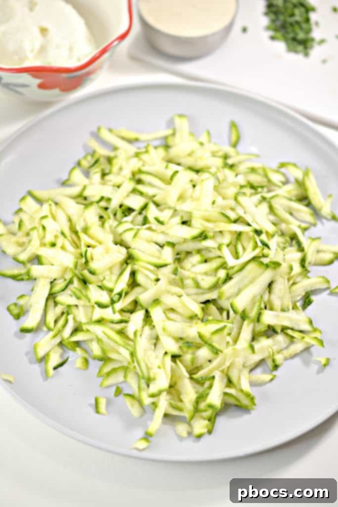 Savory Keto Zucchini Bites 7 Keto Zucchini Fritters preparation step: heating oil in a skillet.