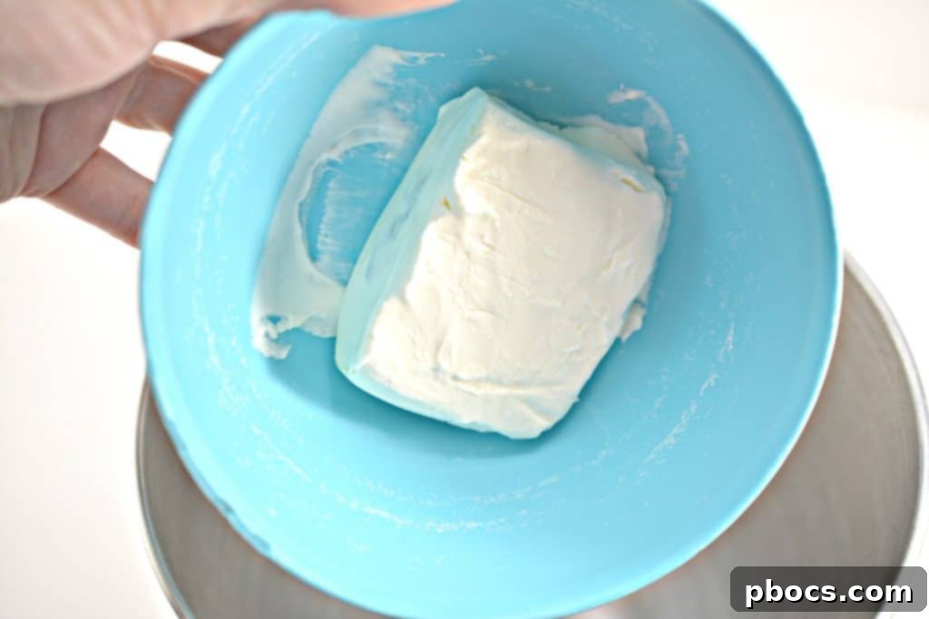 Mixing Cream Cheese, Cheddar, Jalapenos, and Ranch Seasoning for Fat Bombs