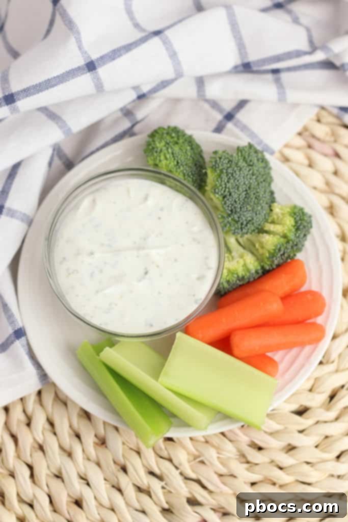 Creamy Greek Yogurt Veggie Dip served in a bowl with fresh celery sticks and colorful vegetables