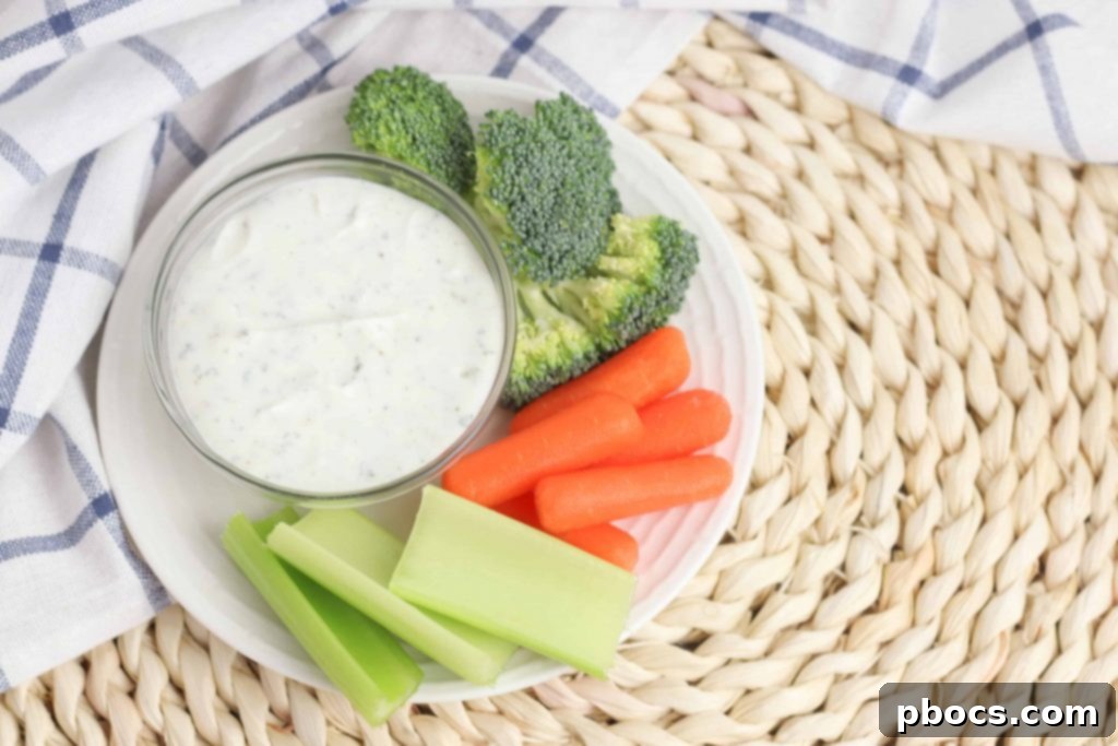 Close-up of Greek Yogurt Veggie Dip in a bowl with a selection of fresh vegetables ready for dipping