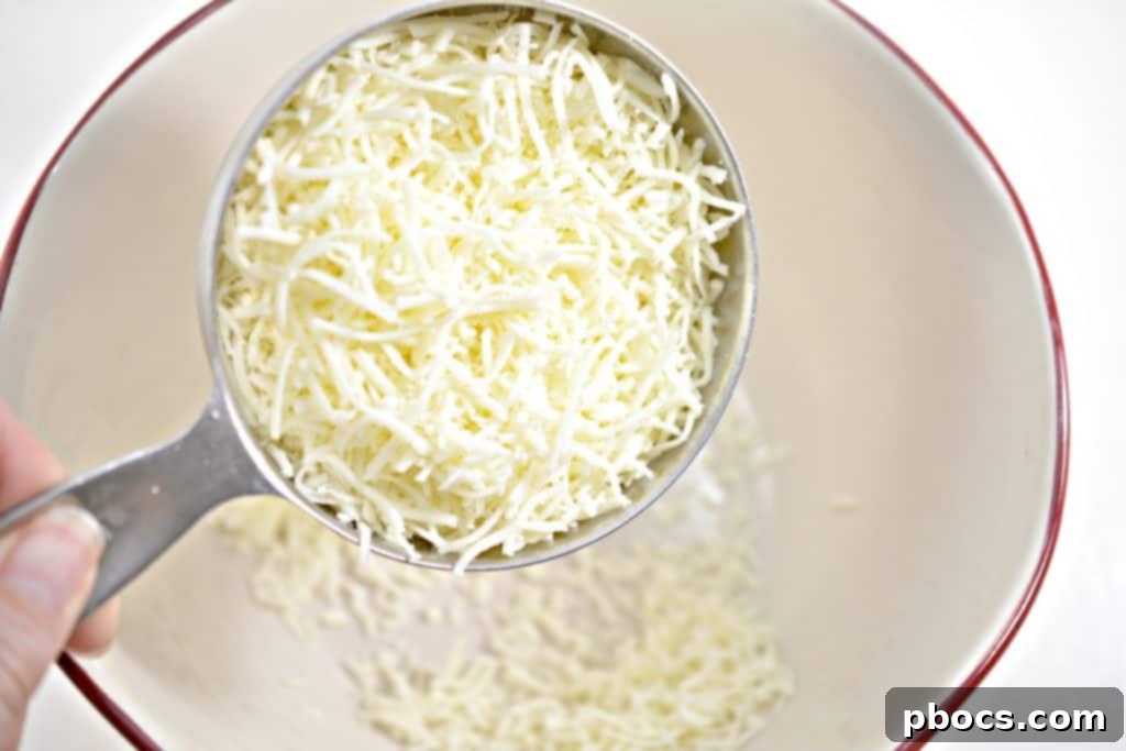 Three strips of bacon cooking in a hot skillet, showing the beginning of the crisping process.