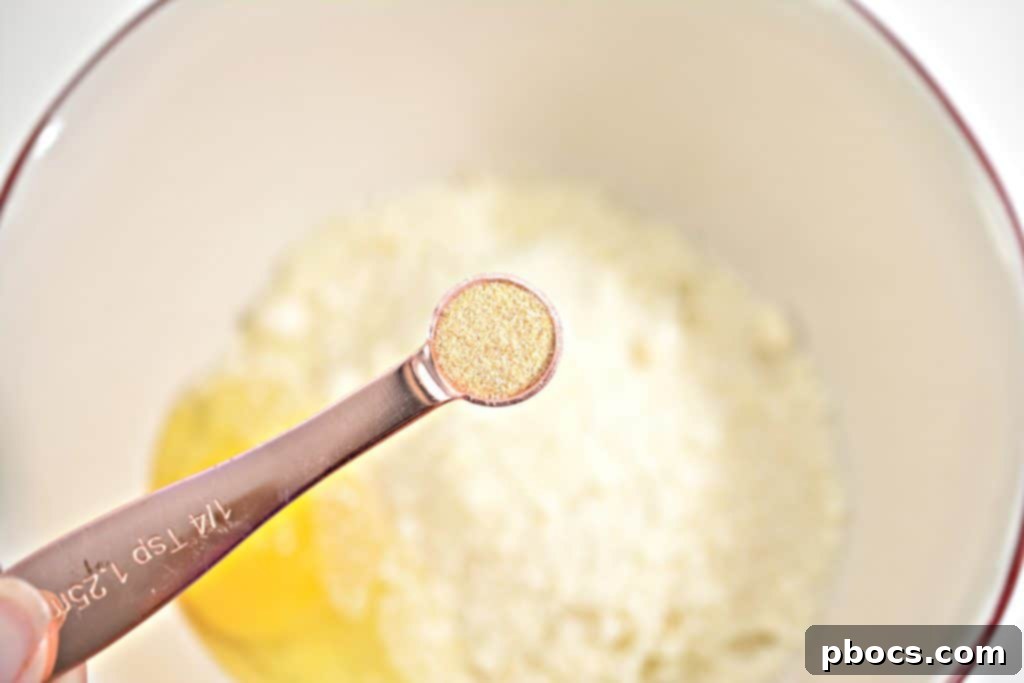 Crispy bacon strips draining on paper towels after being cooked.