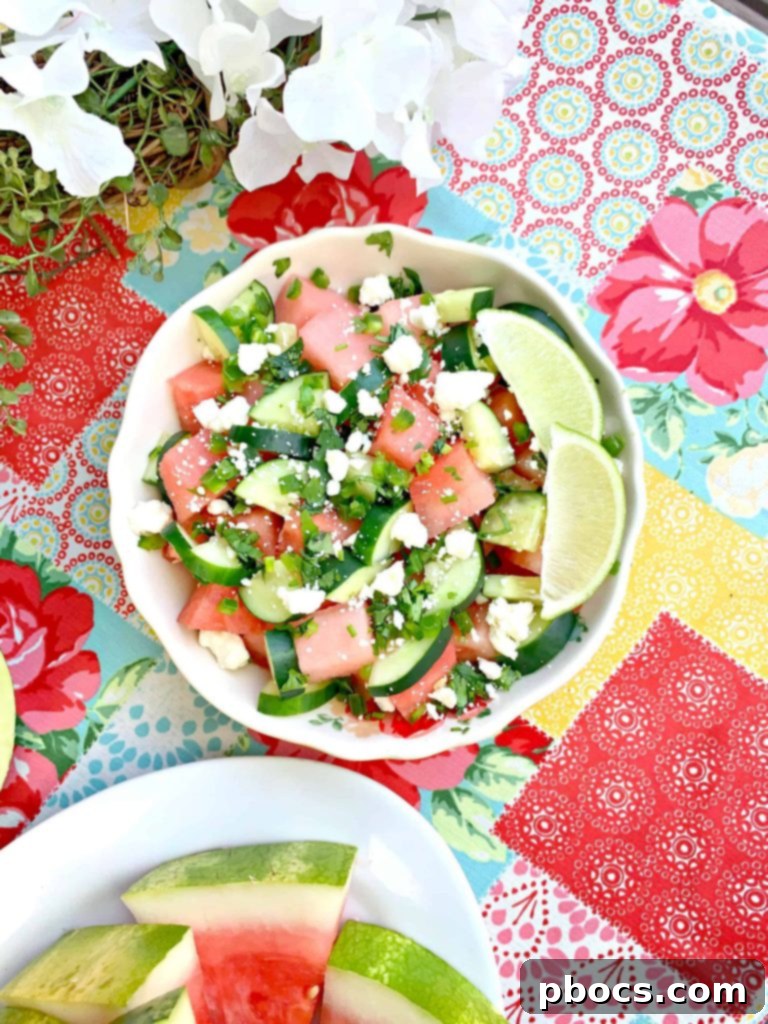 First Cookout with Watermelon Jalapeno Feta Salad 6 A mouth-watering spread of summer cookout food, including grilled burgers, corn, and a vibrant Watermelon Jalapeno Feta Salad, ready for guests.