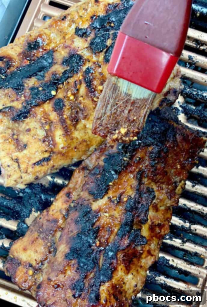 Honey chipotle ribs basting on the grill