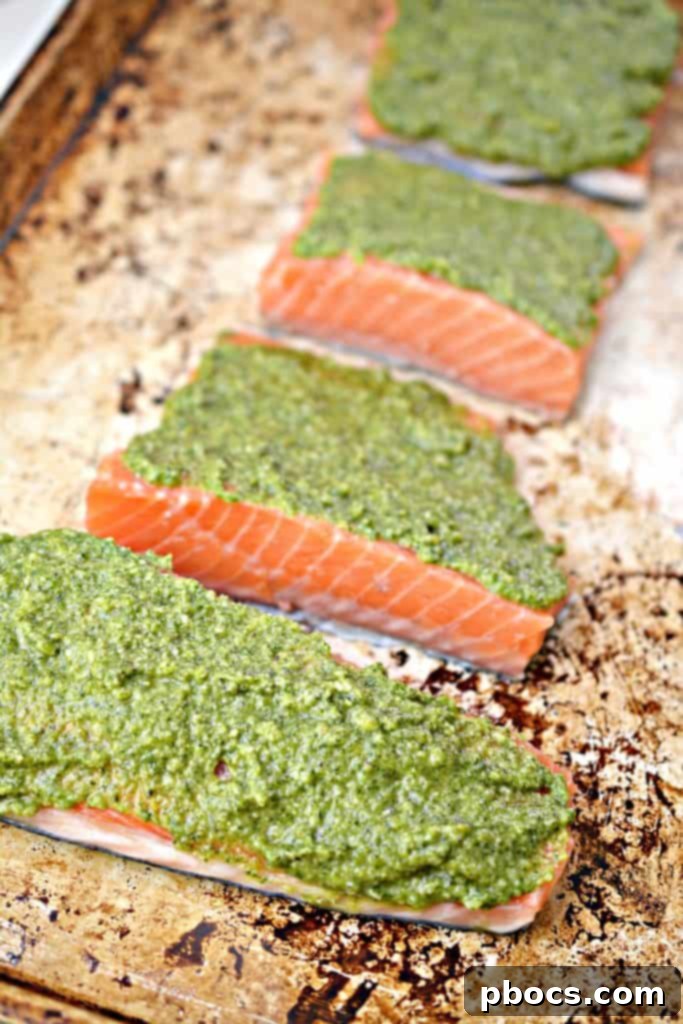 Vibrant Keto Pesto Salmon Bowl 12 Keto Pesto Salmon Bowl - Salmon fillets coated with pesto on a baking sheet