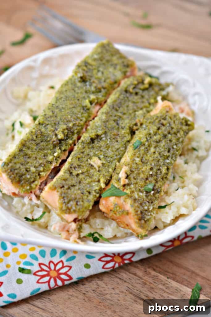 Vibrant Keto Pesto Salmon Bowl 4 Keto Pesto Salmon Bowl - Salmon fillets generously topped with fresh pesto, ready for the oven