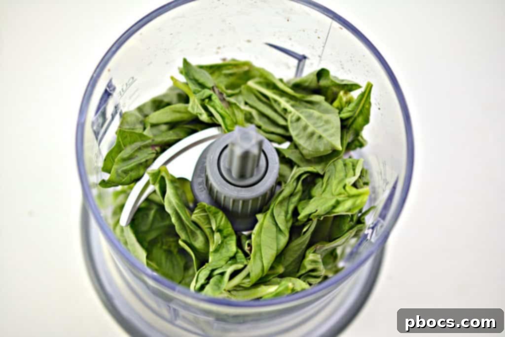 Vibrant Keto Pesto Salmon Bowl 6 Keto Pesto Salmon Bowl - Pesto ingredients being added to a food processor