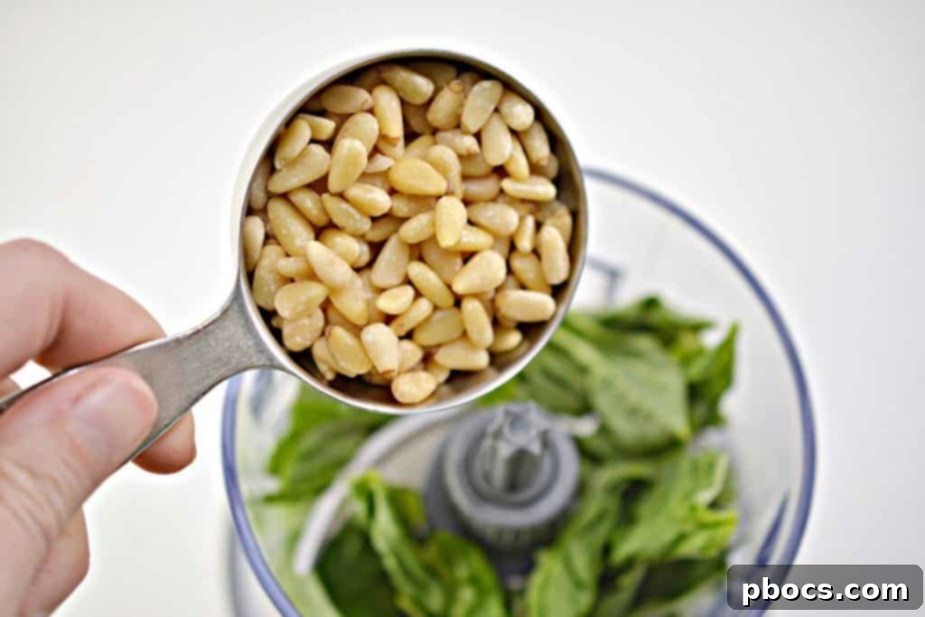 Vibrant Keto Pesto Salmon Bowl 7 Keto Pesto Salmon Bowl - Food processor blending pesto ingredients until smooth