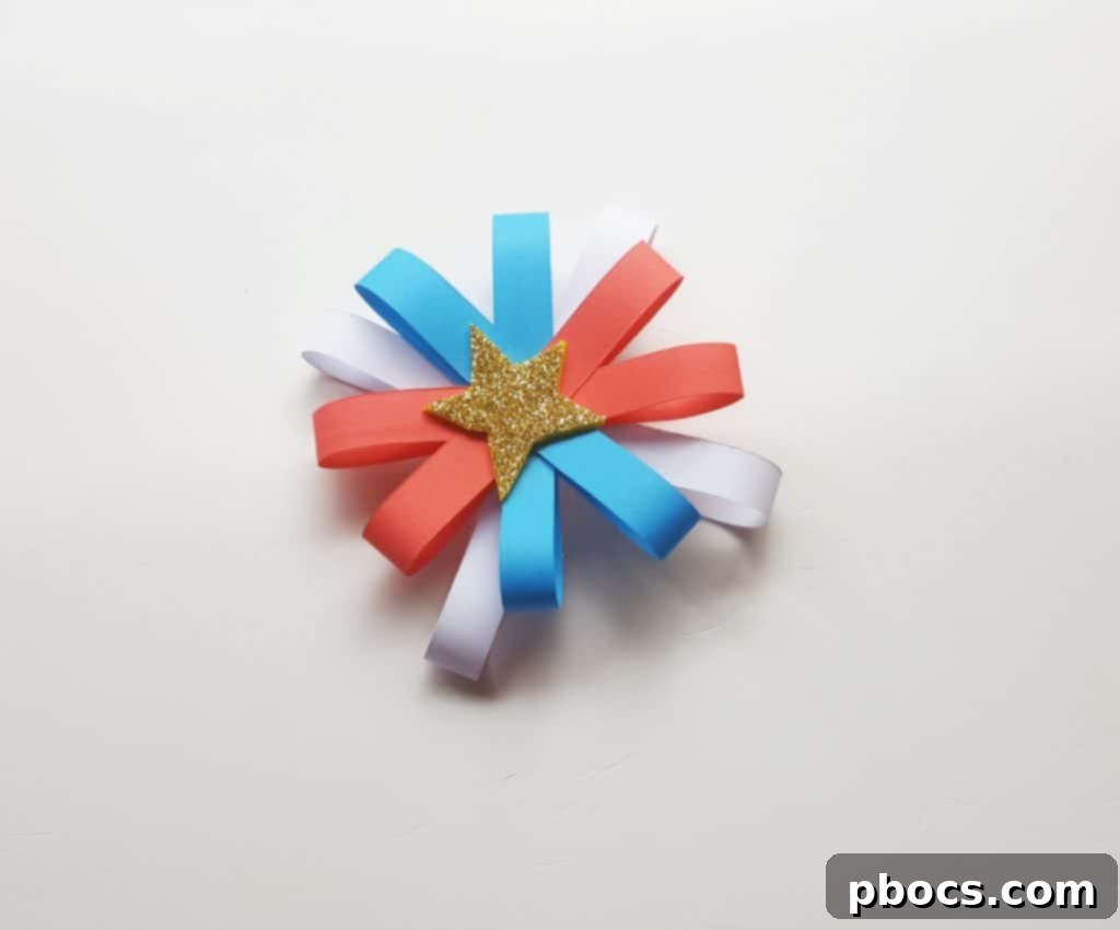 Gluing a golden star to the center of the paper firework