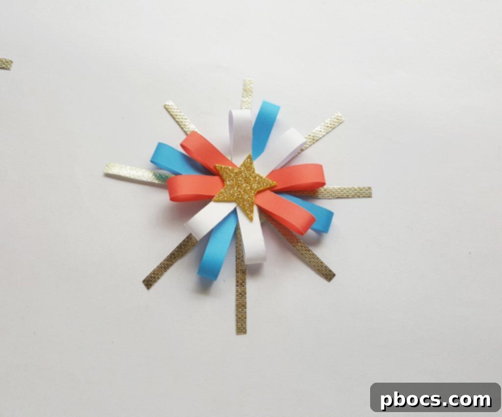 Gluing the looped firework pattern onto the golden strip base