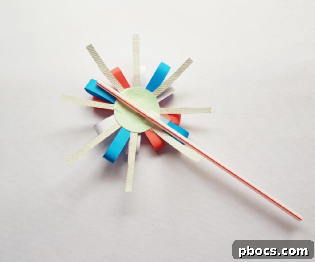 Attaching the straw handle to the back of the paper firework