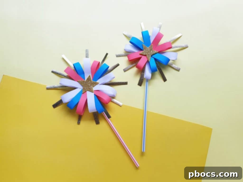 Child proudly holding their completed paper firework craft