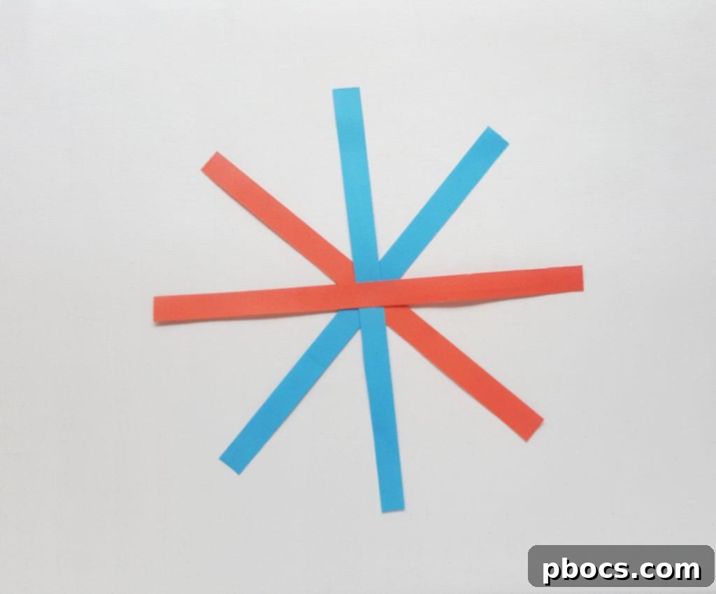 Adding more paper strips crisscross to the center