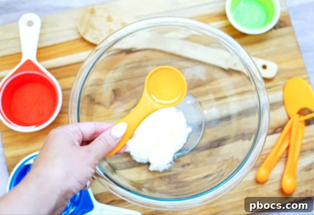 Close-up of the creamy coleslaw dressing being whisked in a bowl