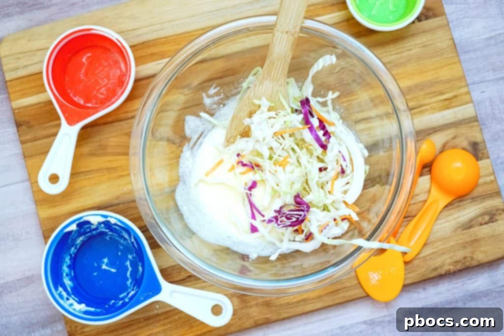 Coleslaw ingredients mixed together until the cabbage is evenly coated with dressing