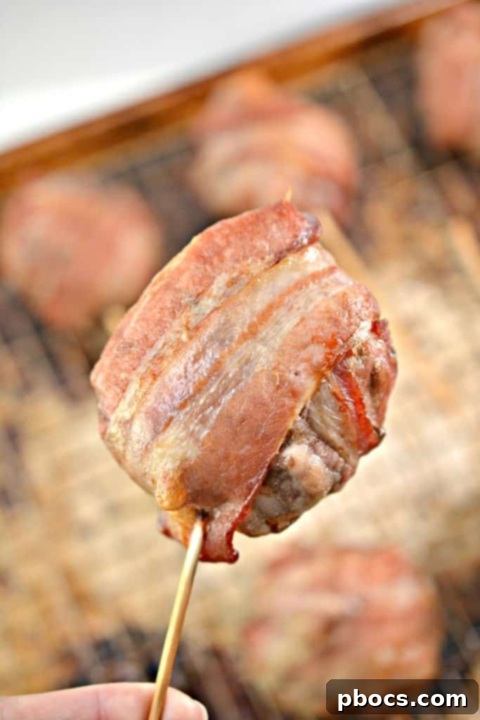 Keto Bacon Cheeseburger Pops 11 Oven-baked Keto Bacon Wrapped Cheeseburger Lollipops cooking on a rack