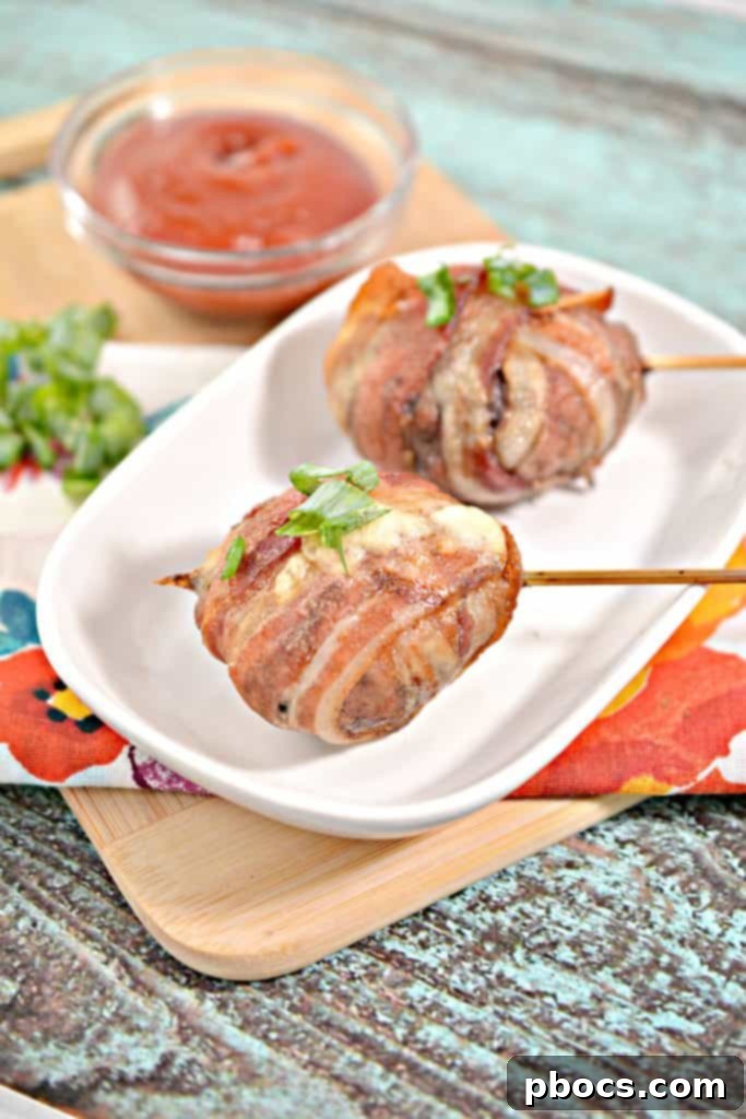 Keto Bacon Cheeseburger Pops 4 Multiple Keto Bacon Wrapped Cheeseburger Lollipops arranged on a white background, ready to be served