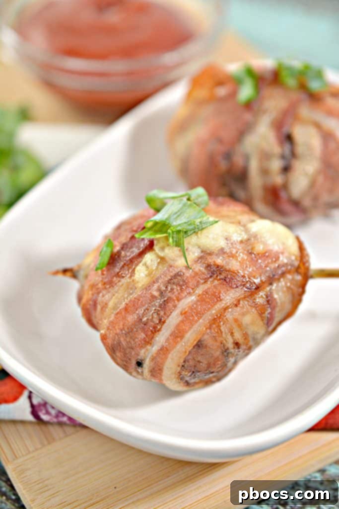 Keto Bacon Cheeseburger Pops 5 A tray of uncooked Bacon Wrapped Cheeseburger Lollipops ready for the oven