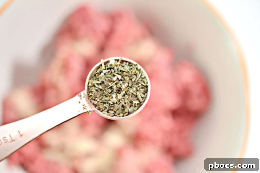 Keto Bacon Cheeseburger Pops 8 Mixing bowl with ground beef and seasonings for cheeseburger lollipops