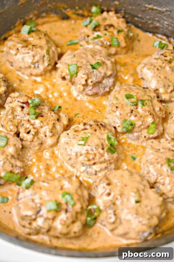 Rich tomato cream sauce simmering in a skillet, ready for the burgers