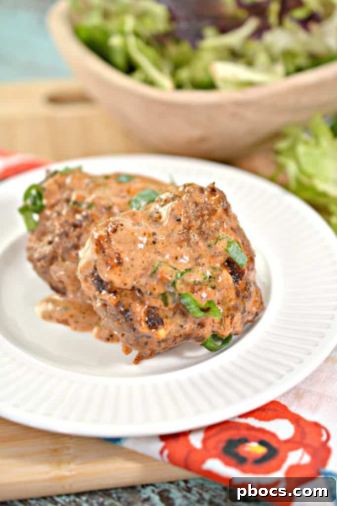 Keto Feta Burgers with vibrant tomato cream sauce garnished with fresh herbs