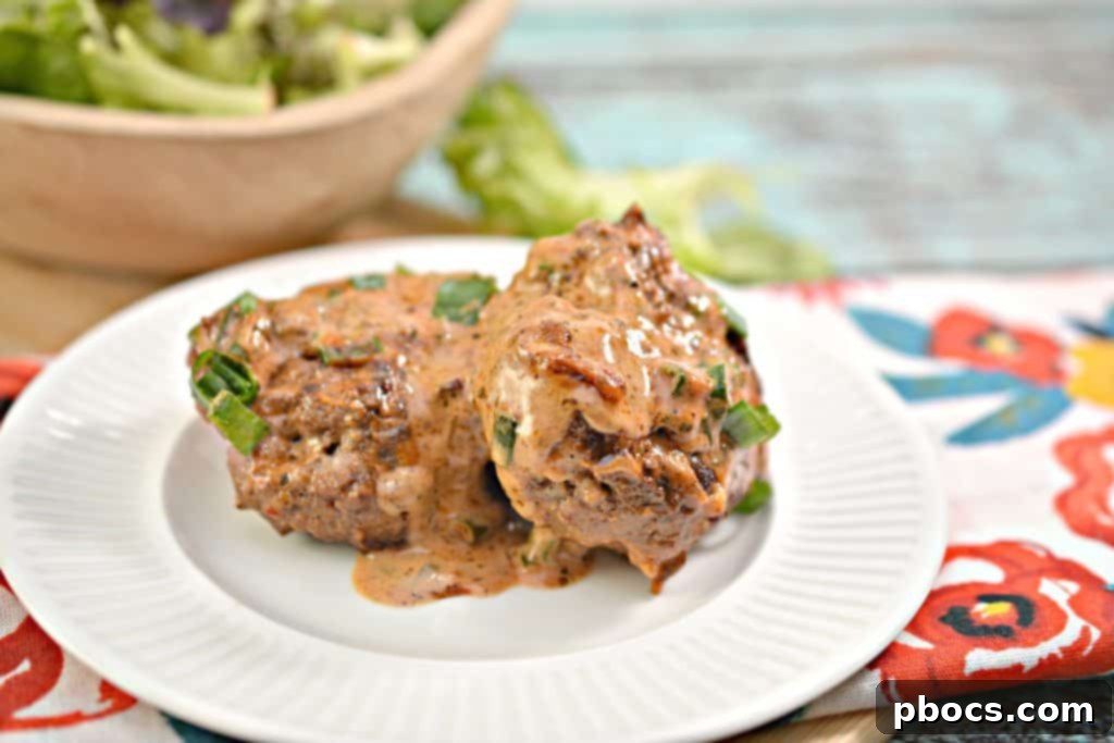 A serving of Keto Feta Burgers with tomato cream sauce and a side of green onions