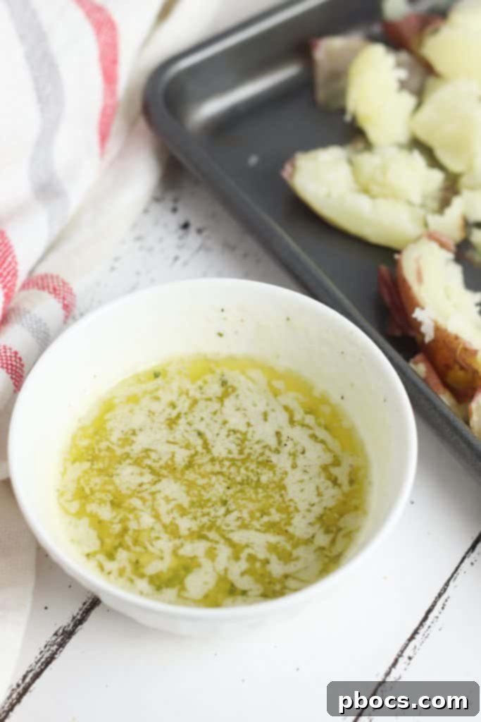 Smash Hit Bacon Cheddar Ranch Potatoes 12 Smashed red potatoes arranged on a baking sheet