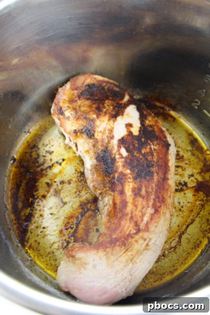 Seasoning and searing the Instant Pot Low Carb Pork Tenderloin