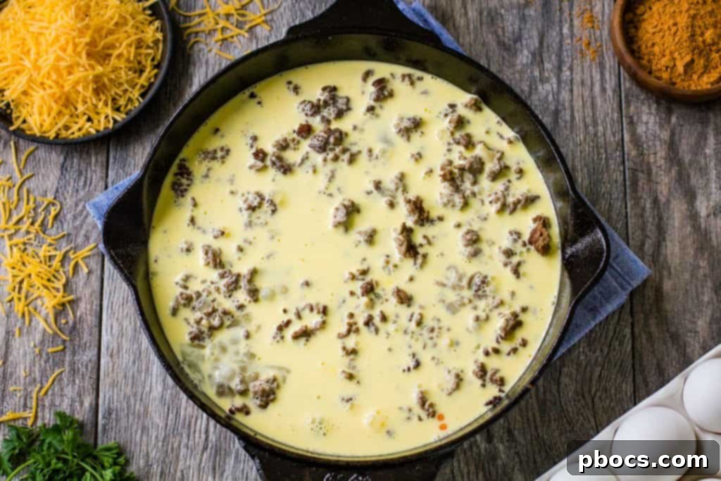 Keto Crustless Taco Casserole 11 Crustless Taco Pie topped with cheese before baking