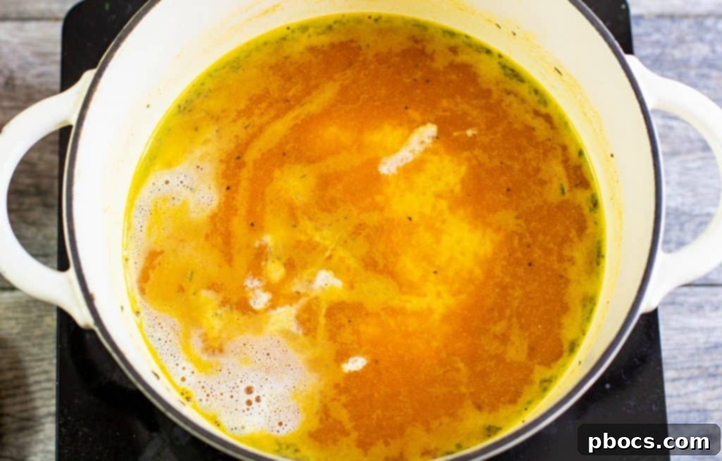 Adding cream to Keto Pumpkin Soup