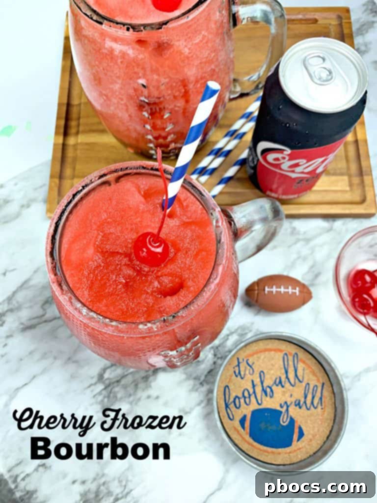Cherry Frozen Bourbon Slushie in a glass, ready for a game day party