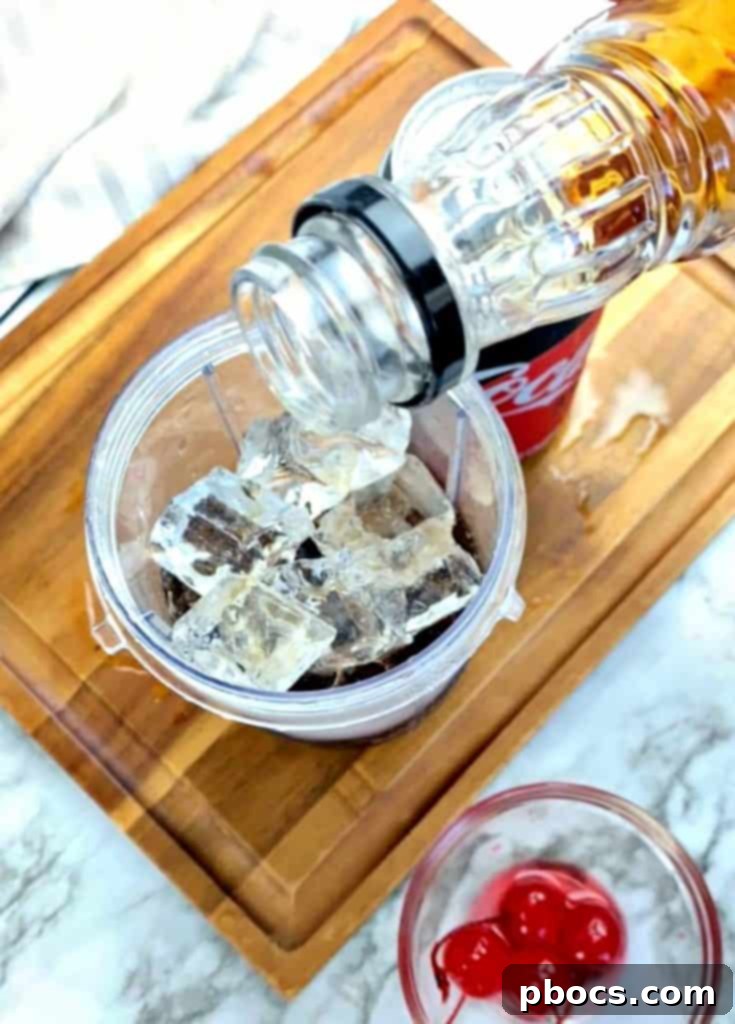 Blender with Cherry Frozen Bourbon Slushie mixture