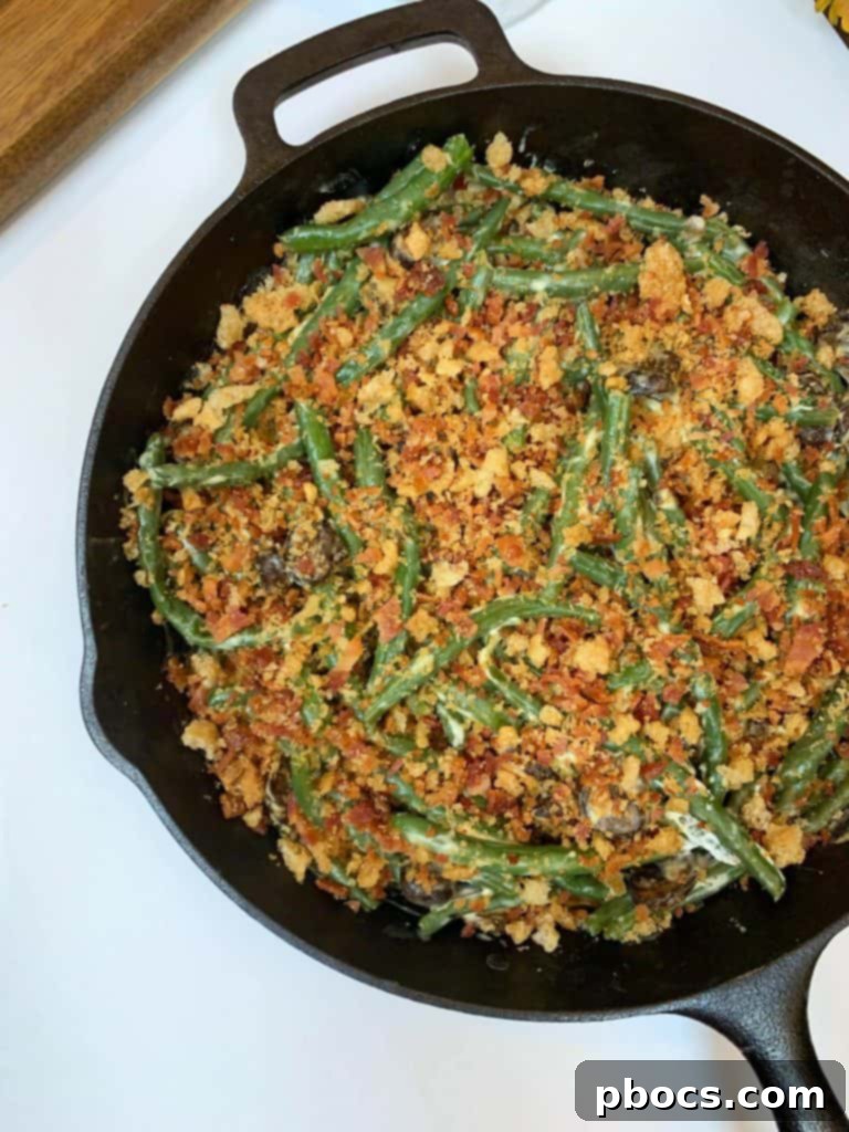 Rich and creamy Keto Green Bean Casserole topped with crispy bacon and pork rinds