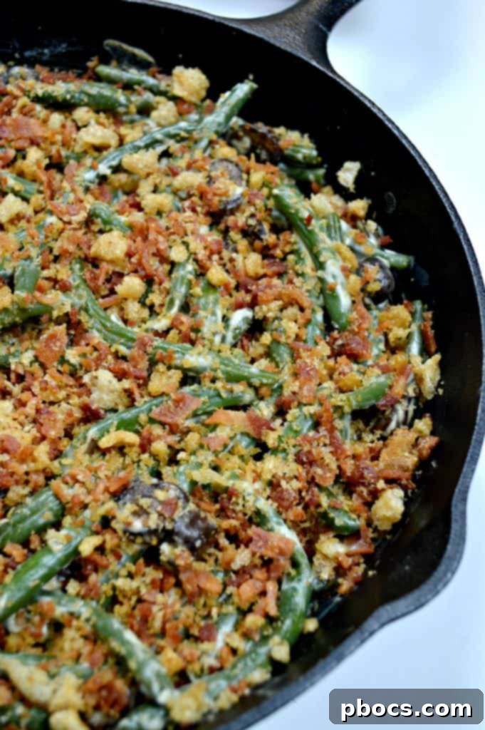 Close-up of freshly cooked Keto Green Bean Casserole in a cast iron skillet