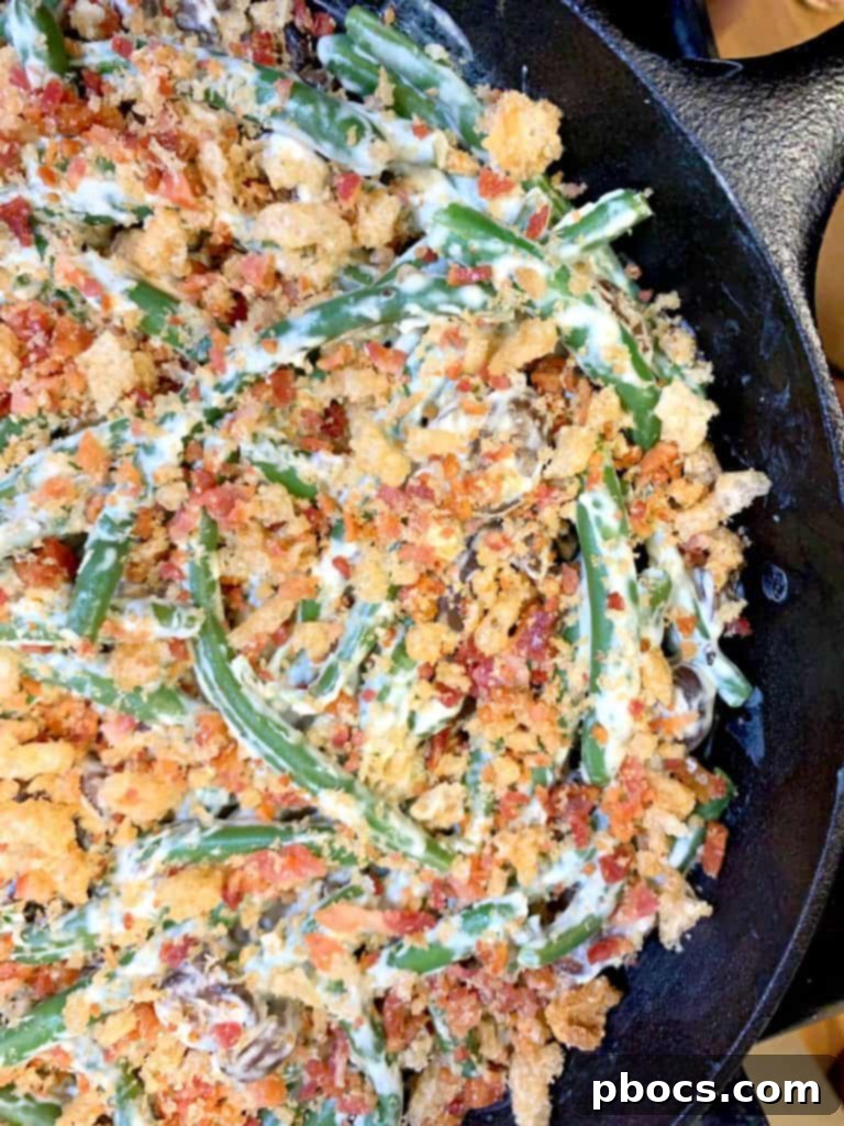 Keto green bean casserole with pork rinds and bacon topping before baking
