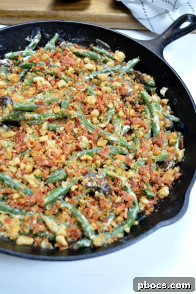 Serving spoon scooping Keto Green Bean Casserole from a white dish