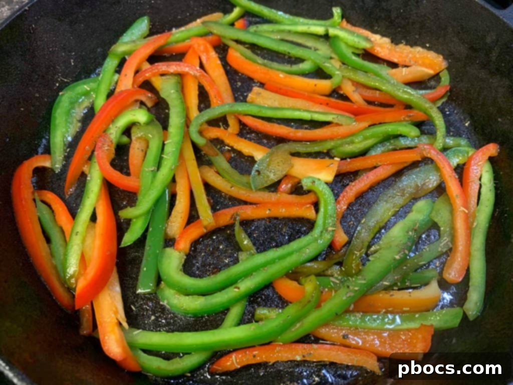 Sautéing Diced Red and Green Bell Peppers in a Skillet with Butter