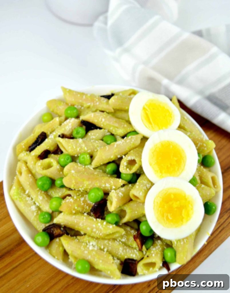 Pea Pesto Pasta Bowl A bowl of uncooked Modern Table Penne pasta, showcasing its natural texture.