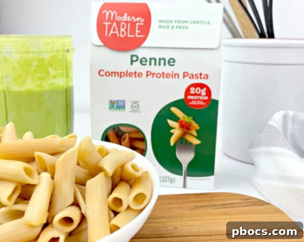 Emerald Pesto Pasta Bowl 4 A serving bowl filled with pea pesto pasta, topped with mushroom bacon and fresh peas.